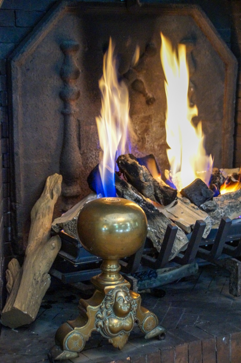 Gas fireplace decorated as wood-burning fireplace