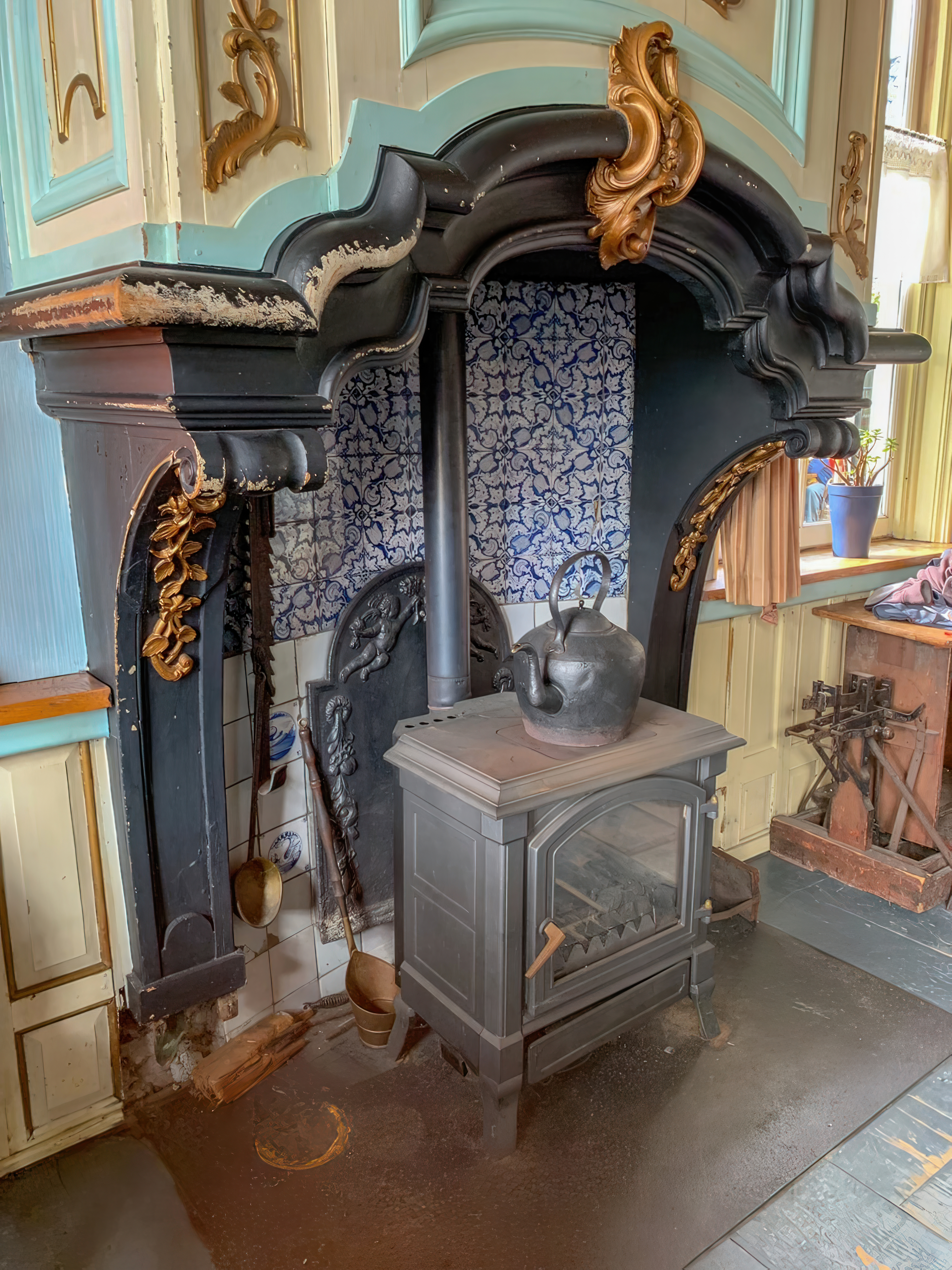 Fireback as a wood stove heat shield in a kitchen