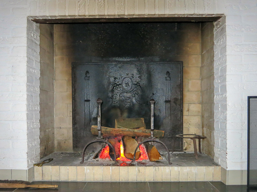 Modern fireplace decorated with antique fireplace accessories