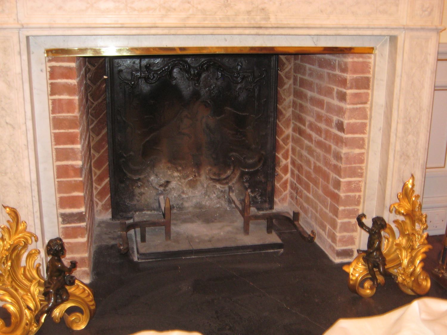 Fireback in fireplace in Wiltshire, UK sourced from https://www.firebacks.net