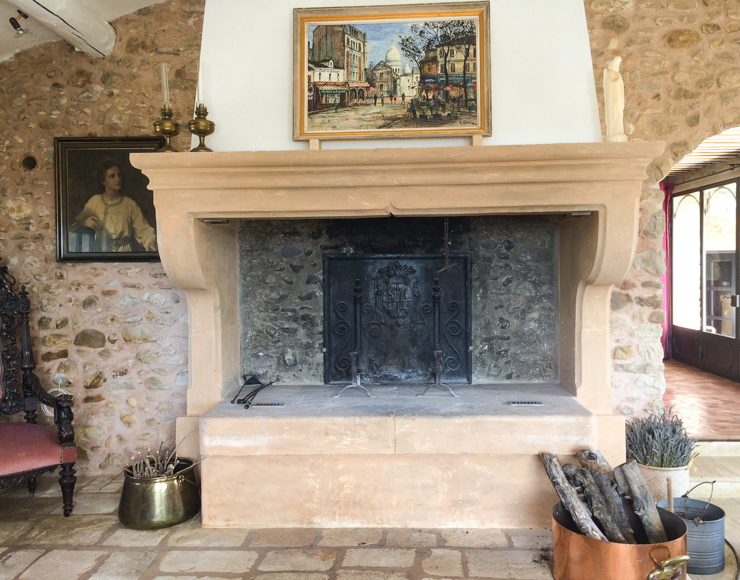 Fireback in fireplace in the Provence, France sourced from https://www.firebacks.net