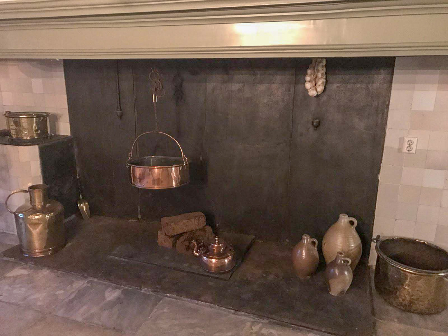 Unused fireplace with cooking accessories