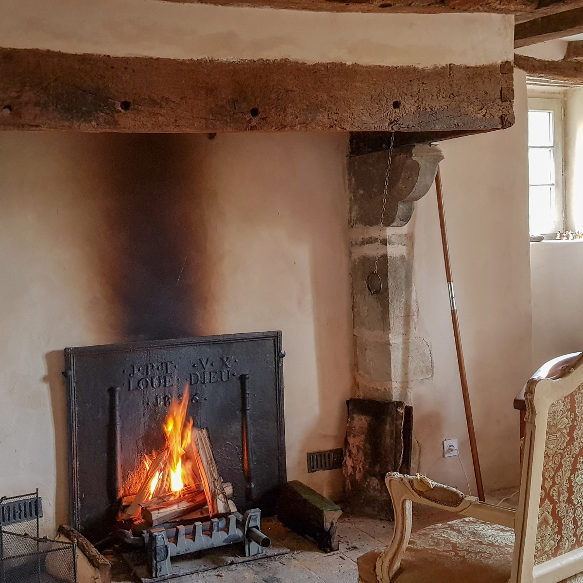 Antique French fireback in a French castle fireplace