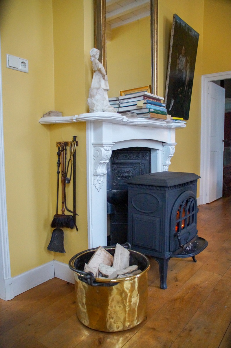 Antique German firebacks behind a modern wood-burning stove