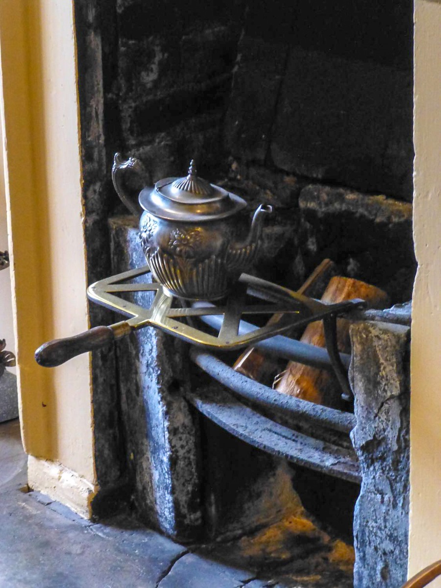 Unused fireplace with cooking accessories