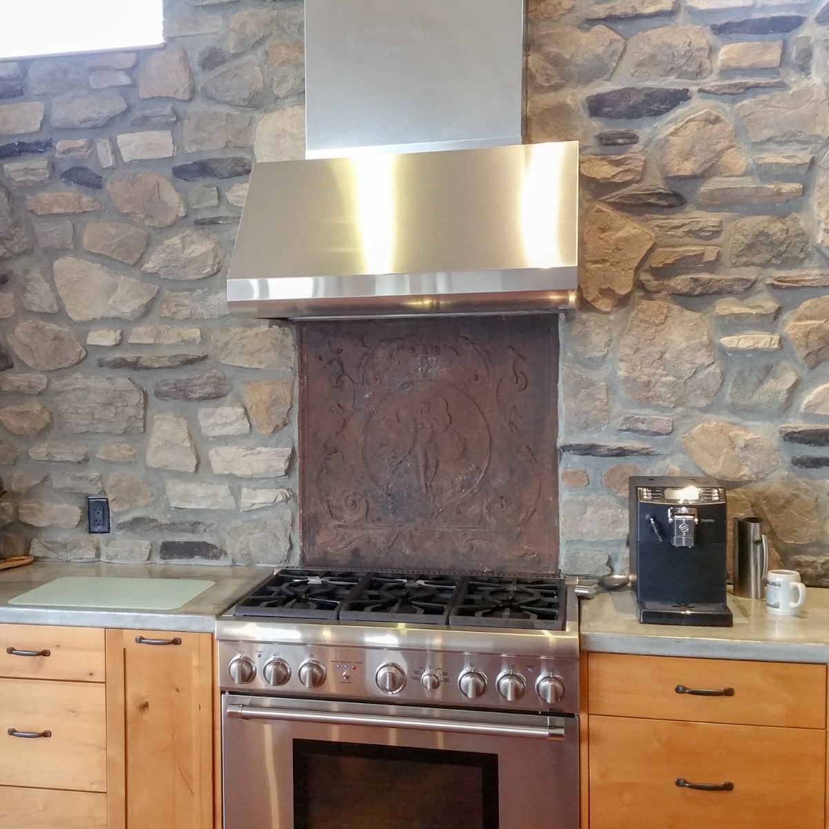 Antique Venus fireback in a modern Canadian kitchen