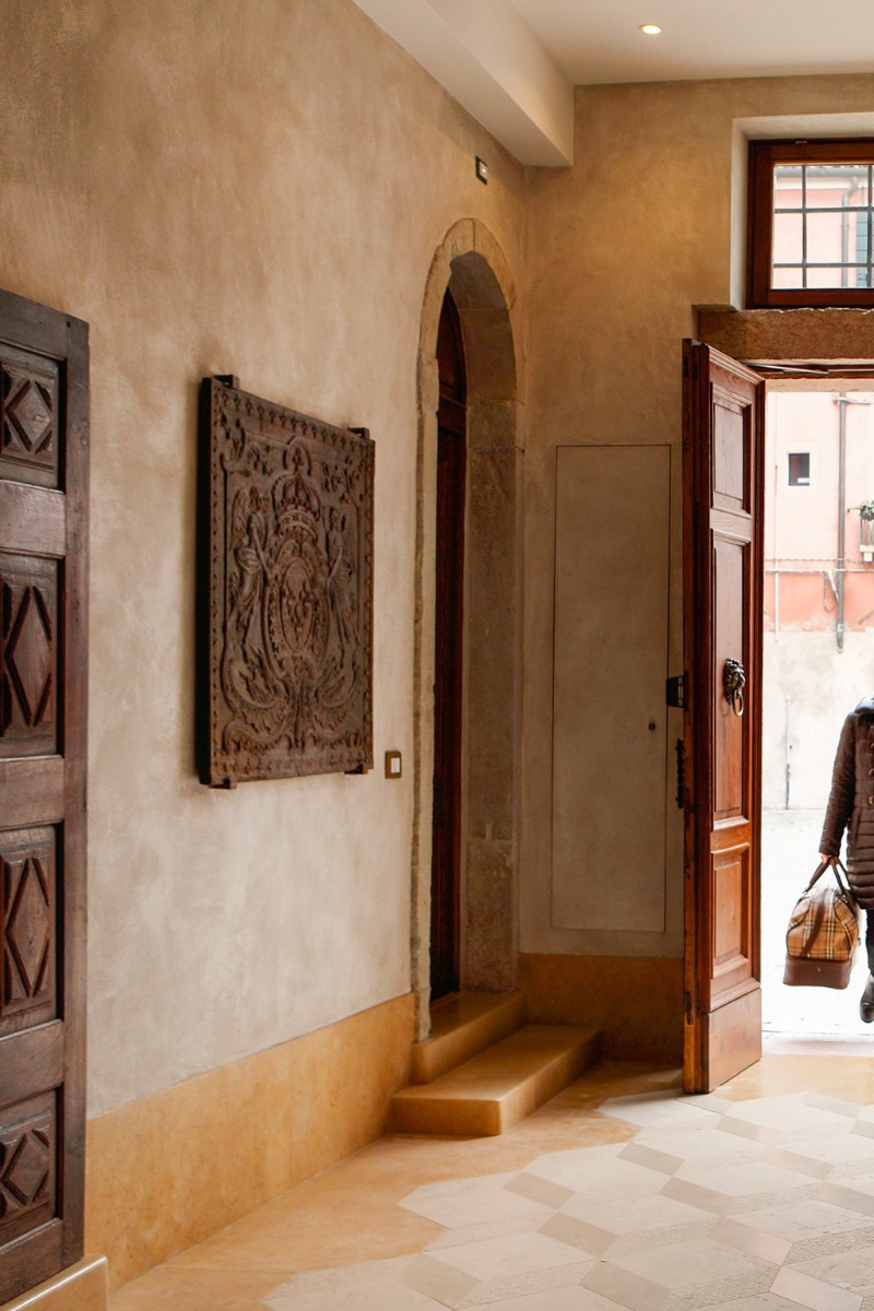 Large antique French fireback in a reception hall of a hotel in Venice