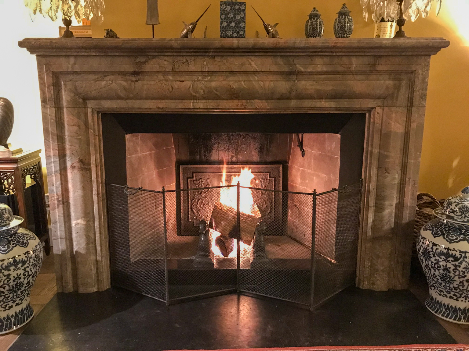 New, handmade French 4-panel fireplace screen (50 cm high) in antique fireplace with antique fireback and antique andirons