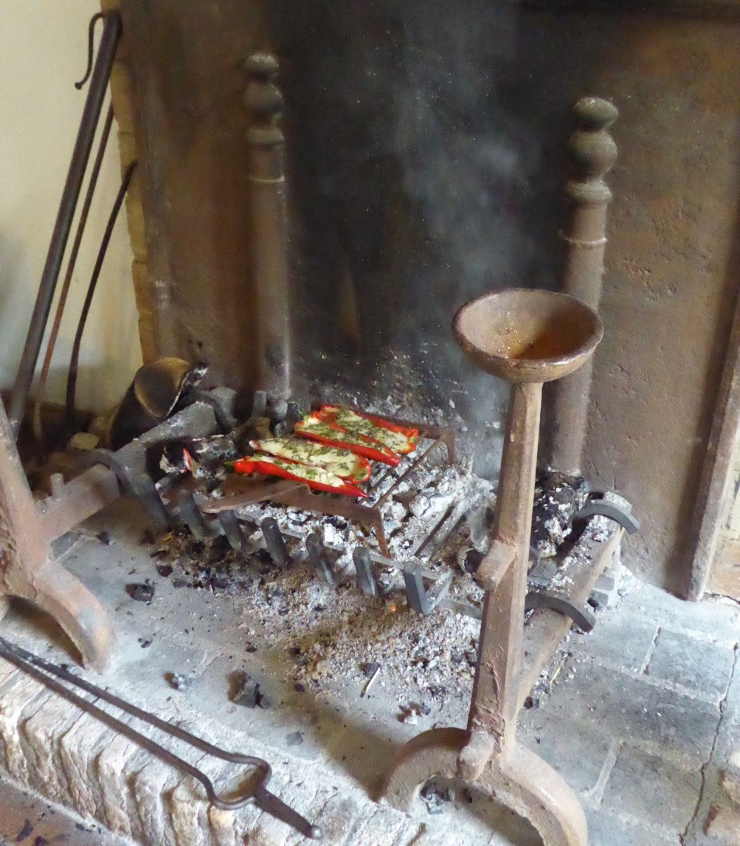 Grilling peppers in the open fireplace