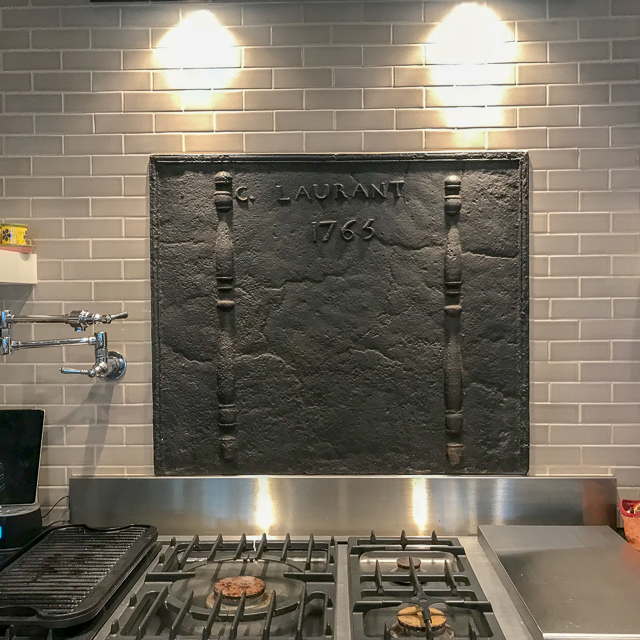 Fireback wall-mounted as backsplash with mounting brackets