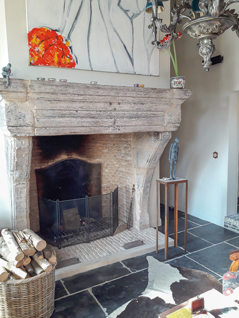 Nicely decorated fireplace with antique fireplace accessories