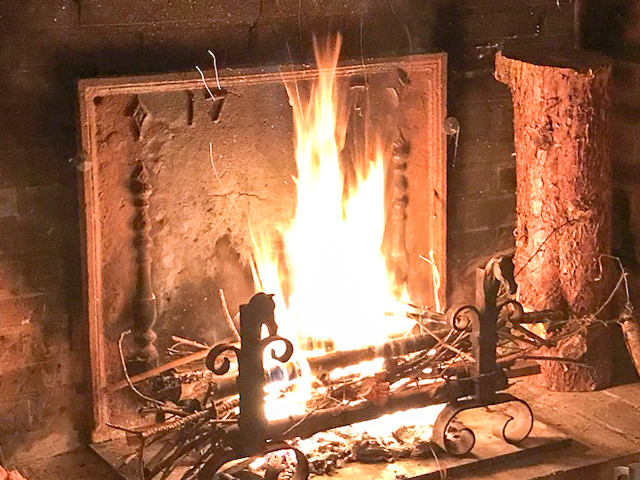 A fireplace fireback installed with 1 pair of mounting brackets